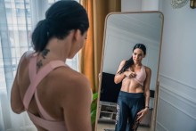 Young woman looking at herself in a mirror