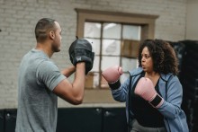 Obese woman in boxing session with her trainer